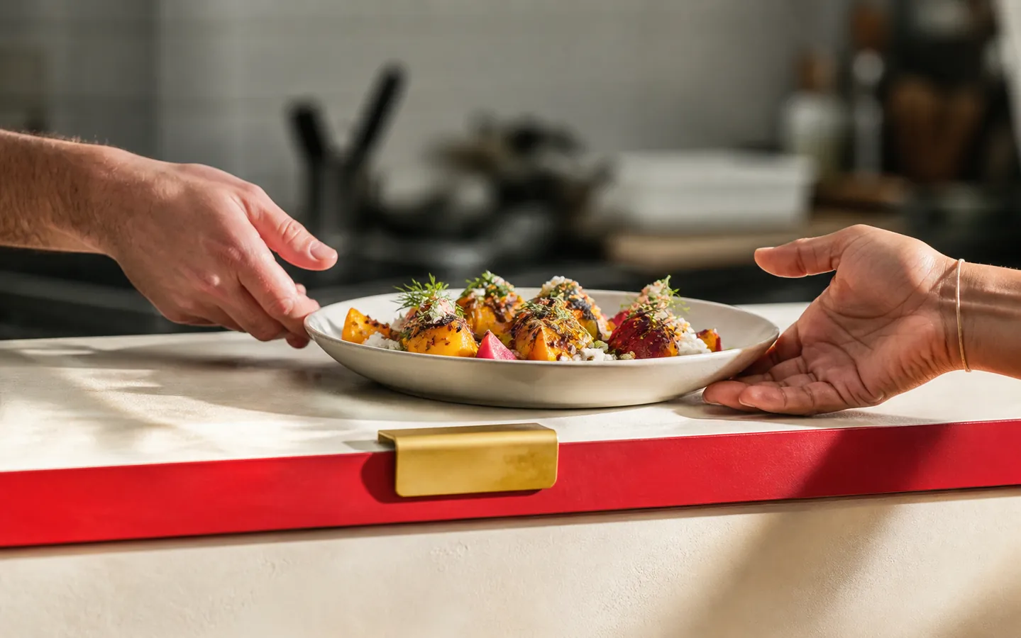 Unbranded concept kitchen handoff; not a photograph of Tini operations.